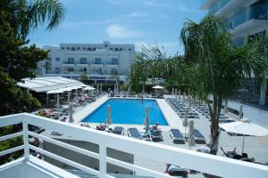 a view of the pool from the balcony of a hotel at Flisvos Beach Apartments in Protaras