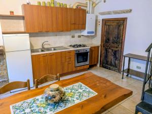 a kitchen with a wooden table with a vase on it at Lucoli Antico in Vado Lucoli