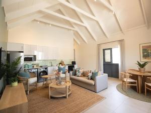 a living room with a couch and a table at Cornercade | Unit 1 in Hermanus