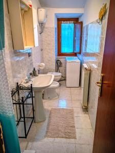 a bathroom with two toilets and a sink at Lucoli Antico in Vado Lucoli