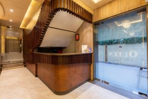 a lobby with a spiral staircase in a building at Hotel Olten in Mumbai