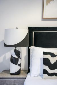 a black and white lamp sitting next to a bed at Cambridge Apartment in Glasgow +31 photos