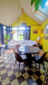 a living room with a table and a couch at La Demeure du Figuier in Évran