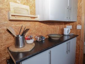 a kitchen counter with a utensils in a pot at Rhosgranog Shepherds Hut in Haverfordwest +1 photo
