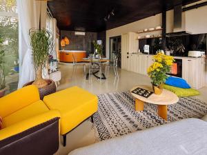 a living room with a yellow couch and a table at The View Boutique Hotel in Vung Tau