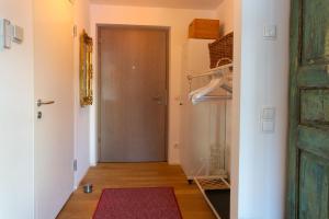 a hallway with a door and a pink rug at Karwendelperle -419- in Mittenwald