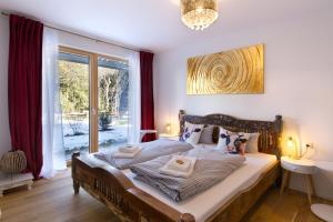 a bedroom with a large bed and a large window at Karwendelperle -419- in Mittenwald