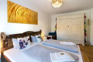 a bedroom with two beds with blue and white pillows at Karwendelperle -419- in Mittenwald