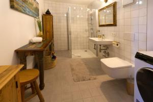 a bathroom with a toilet and a sink and a shower at Karwendelperle -419- in Mittenwald