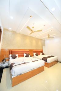 a bedroom with two beds in a room at Hotel Yash Palace in Agra