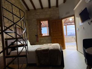 a bedroom with a bunk bed and a ladder at Vouni Calais in Vouni