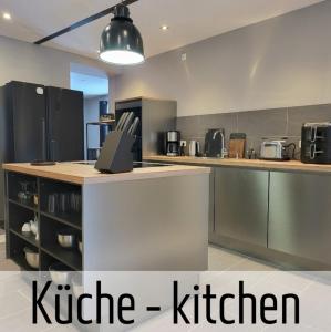a kitchen with a counter top and a kitchen at Lokschuppen - Backstein-Loft in Bad Oeynhausen