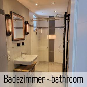 a bathroom with a sink and a shower at Lokschuppen - Backstein-Loft in Bad Oeynhausen