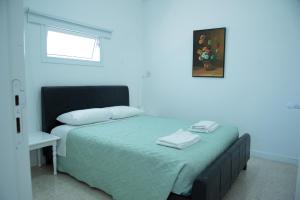 a bed with two towels on it in a bedroom at Flisvos Beach Apartments in Protaras