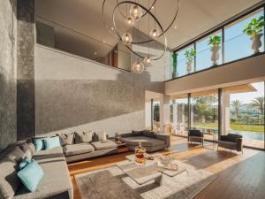 a living room filled with furniture and a chandelier at The Norm Collection Door'a Bodrum in Torba