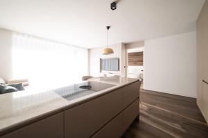 a kitchen with a large sink and a large window at Trutscher Häusl in Villnöss - Chalet in den Dolomiten mit Blick auf die Geisler in Funes +43 photos