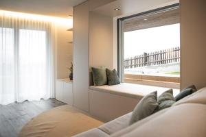 a room with a window with a view of the ocean at Trutscher Häusl in Villnöss - Chalet in den Dolomiten mit Blick auf die Geisler in Funes