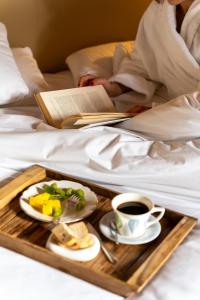 a tray with a plate of food and a cup of coffee at Hotel Miravalle in San Miniato