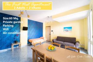 a living room with a table and a couch at Le Ville della Contea -Vacation rentals in Mascali
