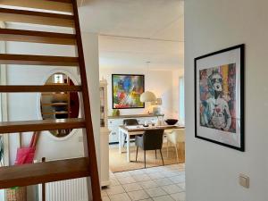 a staircase leading to a living room and a dining room at De Korre 10 in Callantsoog