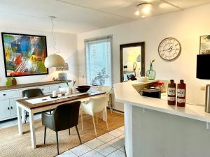 a kitchen with a table and a dining room at De Korre 10 in Callantsoog