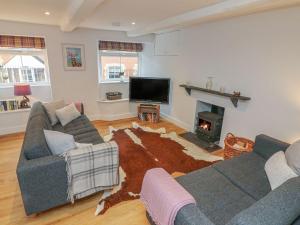 a living room with two couches and a fireplace at The Old Workshop in Dulverton