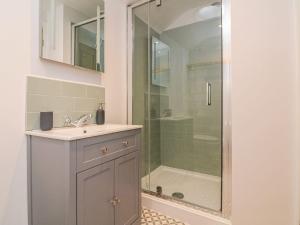 a bathroom with a sink and a shower at The Old Workshop in Dulverton +16 photos