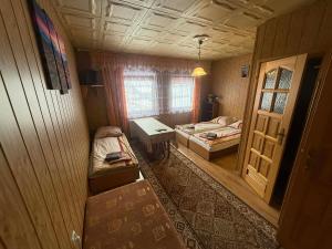 a small room with two beds and a window at U Janiny in Czarna Góra