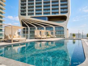 a swimming pool in front of a building at Mercury Suite Designer Apartment with Pool Access in St. Julianʼs