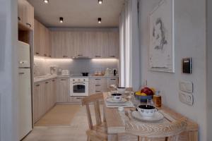 a kitchen with a table with bowls of fruit on it at Areos Luxury Suites in Vóthon