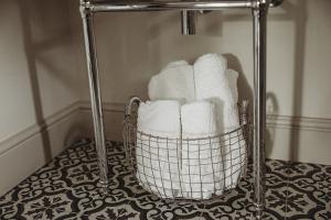 a basket filled with towels sitting on a floor at Ty Bach in Llanwrtyd Wells +51 photos
