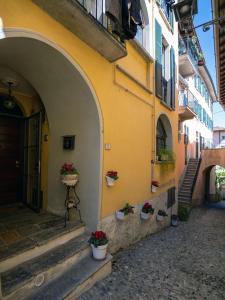 an alley with potted plants on the side of a building at Borgo dei Nonni - Menaggio by LoveComo in Menaggio