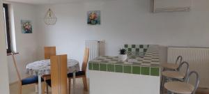 a kitchen with a green and white table and chairs at apartma Kiana in Šempeter pri Gorici