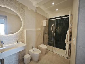 a bathroom with a sink and a toilet and a shower at Villa Greta Hotel Rooms & Suites in Taormina