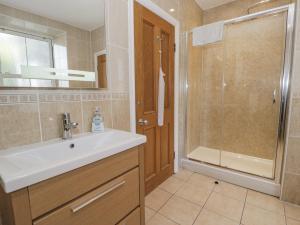 a bathroom with a sink and a shower at Tyddyn Goronwy in Dyffryn +55 photos