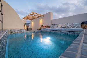 a villa with a swimming pool with a bed at Areos Luxury Suites in Vóthon