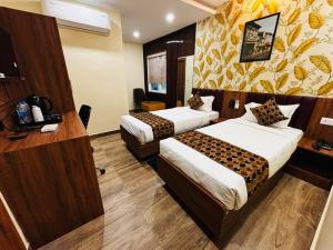 a hotel room with two beds in a room at Hotel Downtown in Jamshedpur