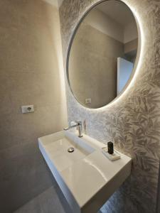a bathroom with a white sink and a mirror at Villa Greta Hotel Rooms & Suites in Taormina