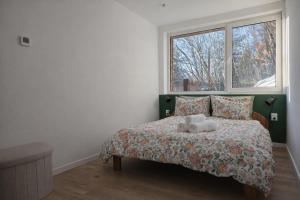 a bedroom with a bed with a teddy bear on it at Domek na Nowej Osadzie in Wisła