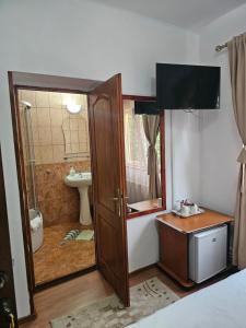 a bathroom with a sink and a toilet and a shower at Villa Foisor in Buşteni +43 photos