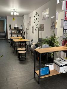 a room with tables and couches and tables and a kitchen at Hostal Lavela in Torrevieja