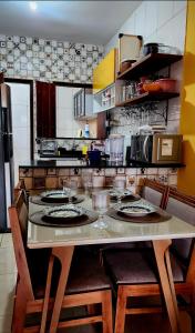 a kitchen with a table with plates and glasses on it at Escapada do Sonho in Lençóis