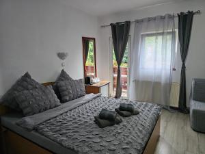 a bedroom with a bed with two stuffed animals on it at Villa Foisor in Buşteni