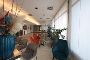 a hallway with chairs and a table in a building at LVG Hotel Collection - Cavour in Novara