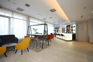 a dining room with a table and chairs at LVG Hotel Collection - Cavour in Novara +31 photos