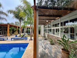 an external view of a house with a swimming pool at Riad Eglantine in Touggana