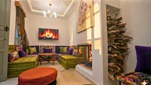 a living room with a couch and a fireplace at Riad Chama in Essaouira