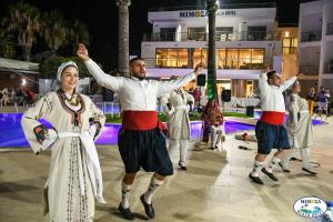 a group of men and women performing a dance at Mimoza Beach Hotel in Yenibosazici +24 photos