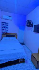 a bedroom with a bed with a blue light at Lux 3bedroom apartment in Okunola +10 photos