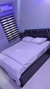a large bed in a room with at Lux 3bedroom apartment in Okunola